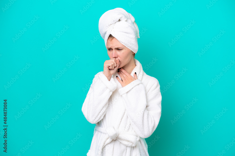 Young woman in a bathrobe isolated on blue background is suffering with cough and feeling bad Young woman in a bathrobe isolated on blue background is suffering with cough and feeling bad
