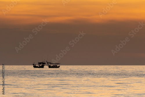 Silhouette of boats on the sea during sunset