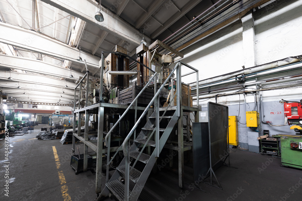 Photo of modern automatic automobile manufacturing workshop. Car production. Industrial scenery background Photo of modern automatic automobile manufacturing workshop. Car production. Industrial scenery background