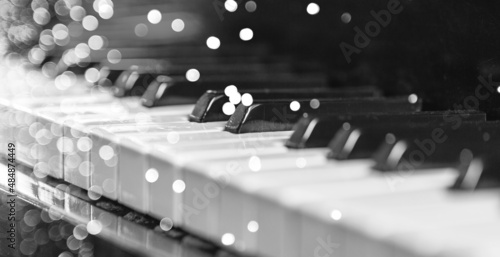 Foto Piano keyboard background. Piano keys with lights