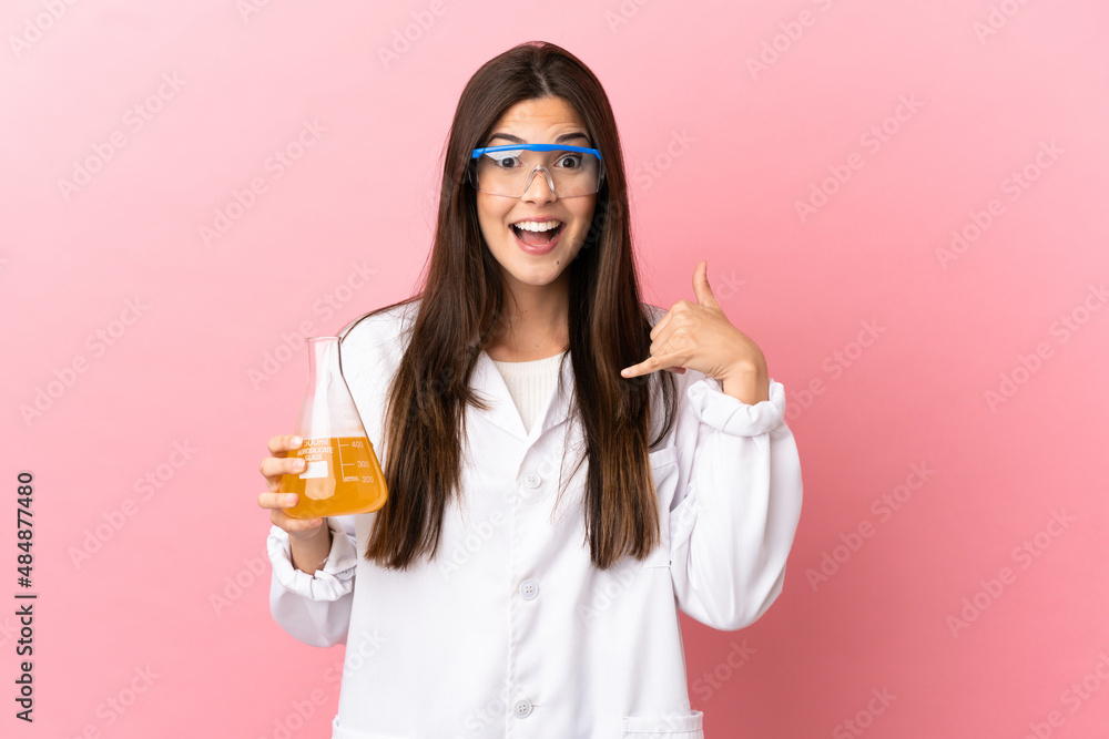 Young scientific girl over isolated pink background making phone gesture. Call me back sign Young scientific girl over isolated pink background making phone gesture. Call me back sign