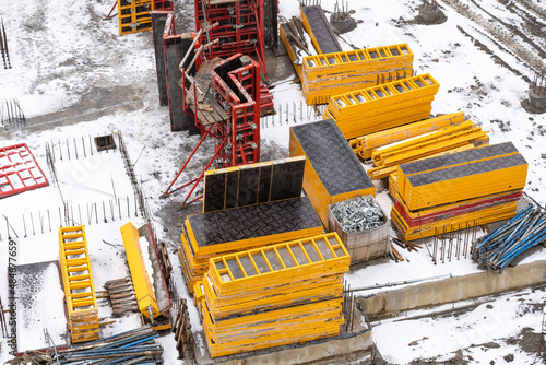 Photography cranes and workers being poured concrete into foundation