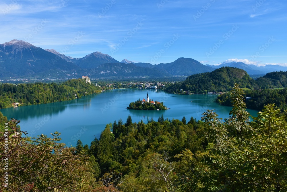 Scenic view of lake Bled in Slovenia with a church on an island and mountains behind