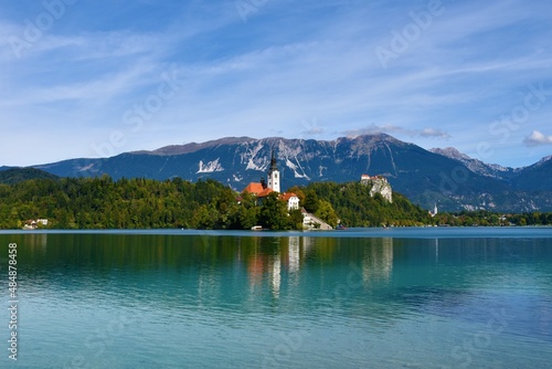 View of beautiful scenery of the island with the church at lake Bled in Gorenjska, Slovenia with Karavanke mountains behind