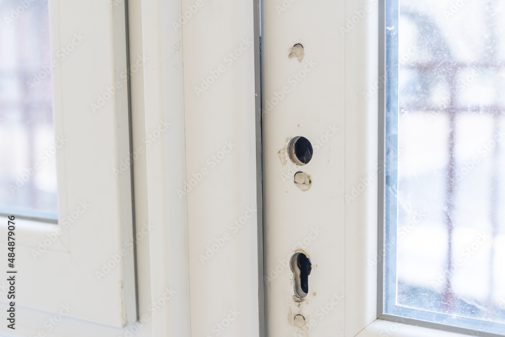 Fragment of the handle and lock of the plastic door during installation Fragment of the handle and lock of the plastic door during installation