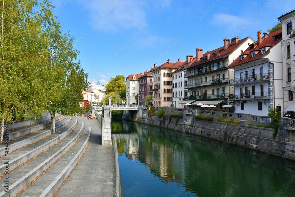 Ljubljanica river canal flowing through Ljubljana, capital city of Slovenia with a reflection of the houses in the river