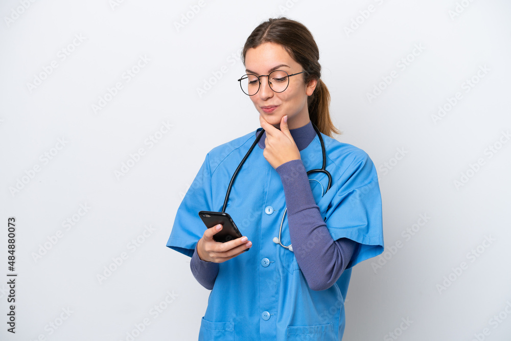 Young caucasian nurse woman isolated on white background thinking and sending a message Young caucasian nurse woman isolated on white background thinking and sending a message