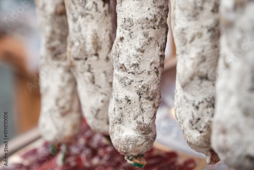 Close up of hanging salami sausages in a street market. Shallow Depth of Field. Hanging dry Sausage.