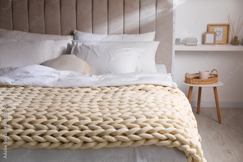 Soft chunky knit blanket on bed in stylish room interior Stock Photo |  Adobe Stock