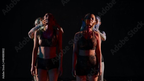 Wallpaper Mural art performance with dyes in darkness, four women are smearing paints on skin Torontodigital.ca