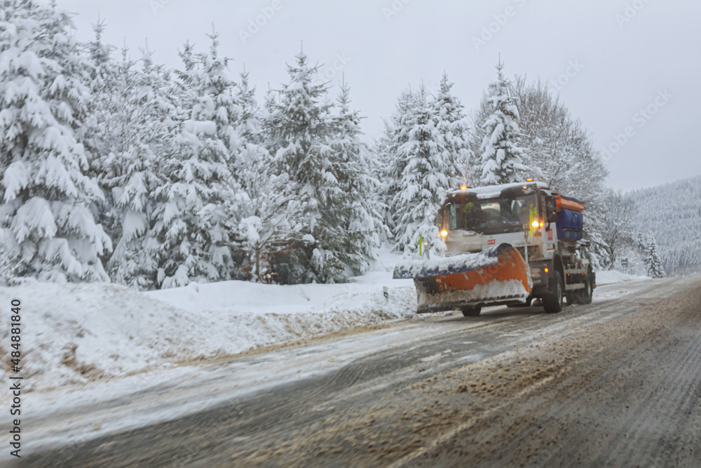 View through the windshield of a car on snow removal equipment. Snow-covered trees and roadsides. View through the windshield of a car on snow removal equipment. Snow-covered trees and roadsides.
