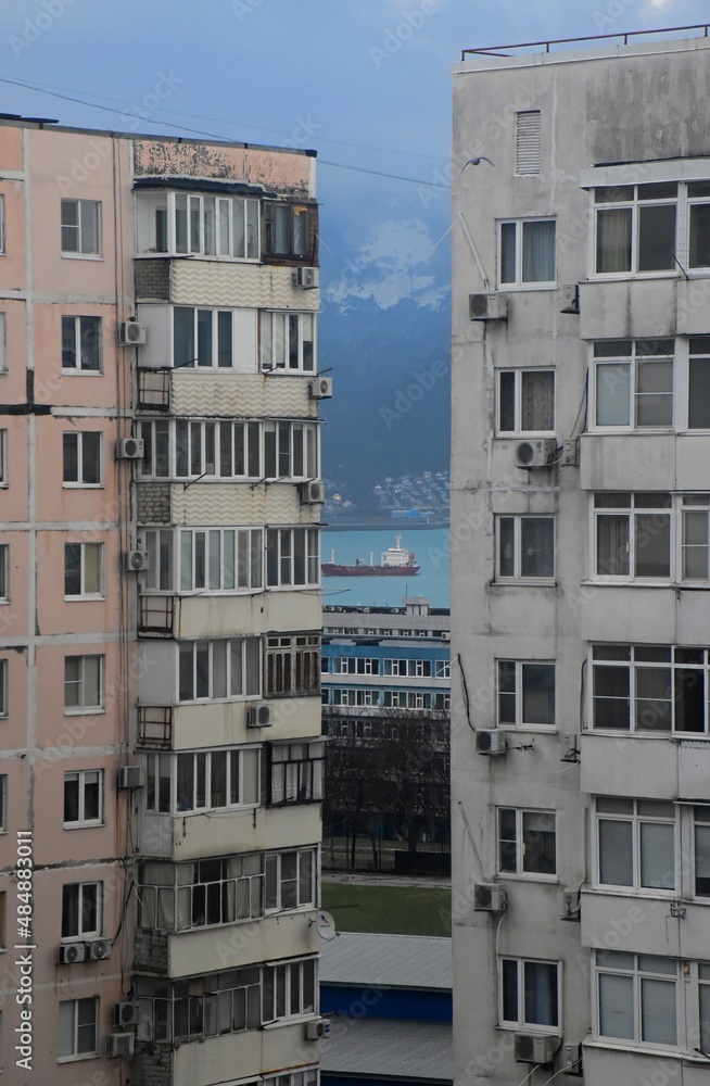 View of the sea coast through the jungle of urban high-rise buildings.