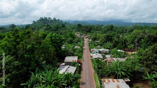 Aerial drone view over a long road in the Micolo village, sunny Sao Tome, Africa photo