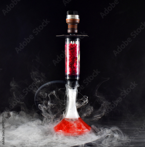 hookah with ice and smoke on black background
