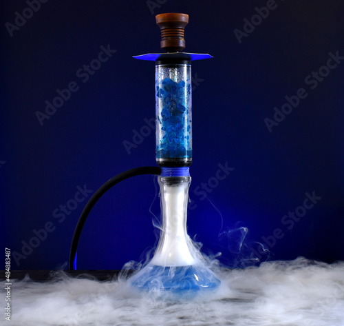 hookah with ice and smoke on black background
