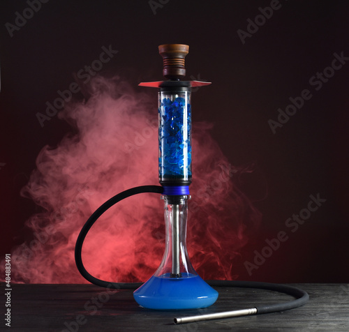 hookah with ice and smoke on black background
