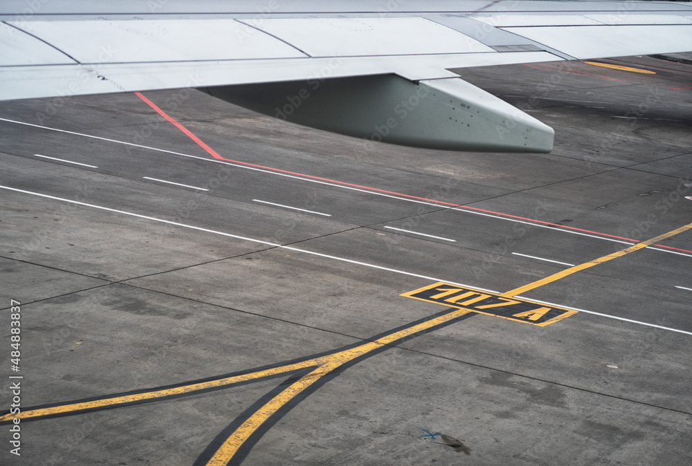 Passenger airplane on runway near the terminal in an airport Passenger airplane on runway near the terminal in an airport