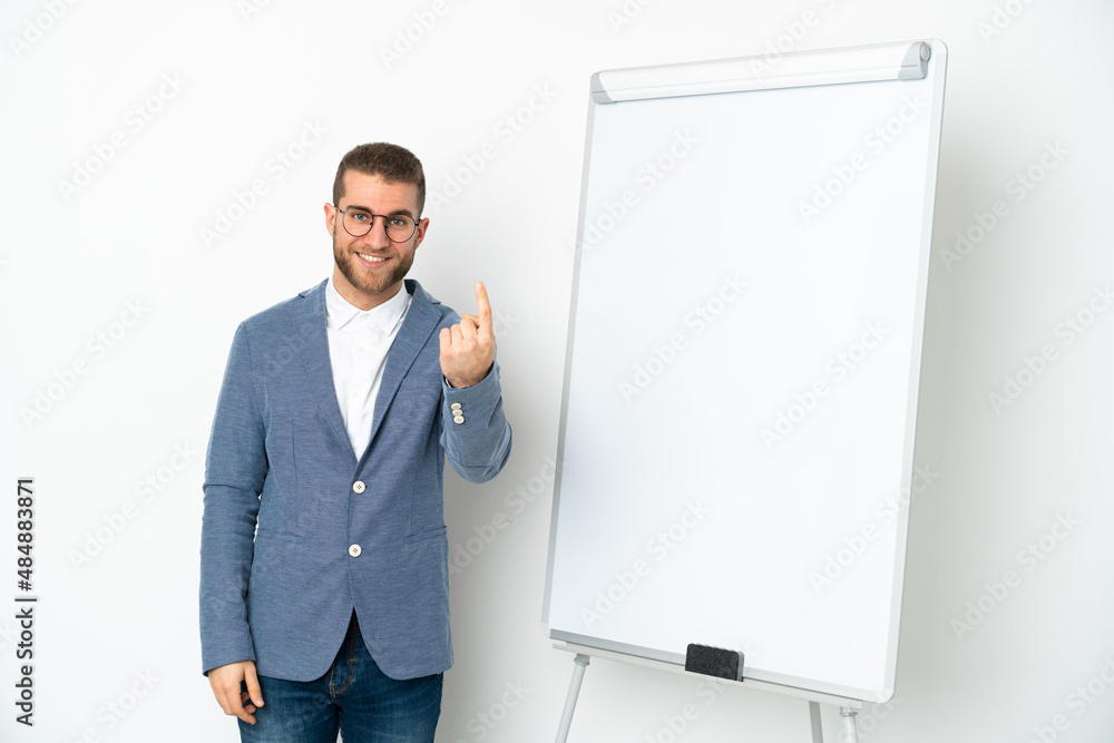 Young business woman giving a presentation on white board isolated on white background doing coming gesture Young business woman giving a presentation on white board isolated on white background doing coming gesture