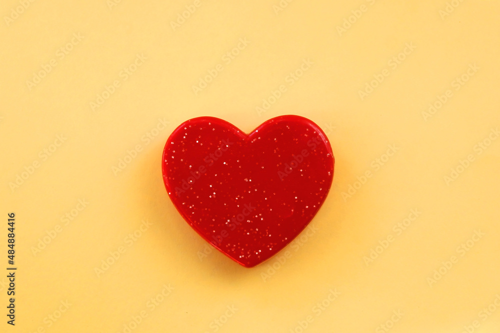 Small red heart on bright yellow background. Love concept. Flat lay. Small red heart on bright yellow background. Love concept. Flat lay.