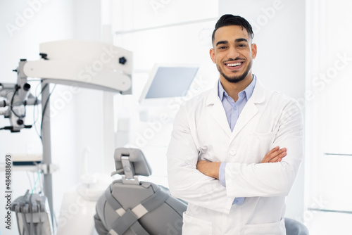 Dental Center. Portrait Of Smiling Middle Eastern Dentist Doctor Posing At Workplace