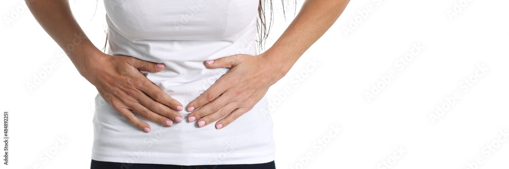 Young woman holding on to sore belly closeup Young woman holding on to sore belly closeup