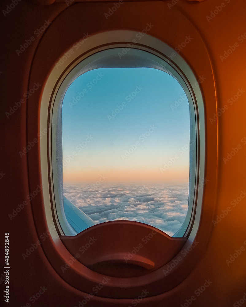 Airplane window at dawn