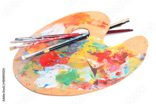 Palette with paints and brushes on white background. Artist equipment