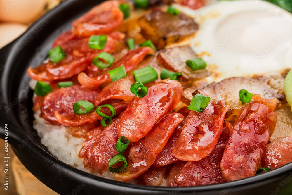 Cantonese style cooking of claypot rice with waxed meats