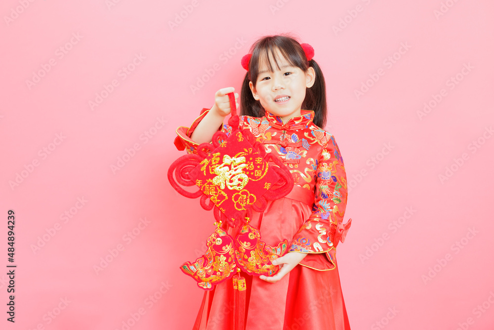 Chinese girl with traditional dressing up and holding a Chinese girl with traditional dressing up and holding a