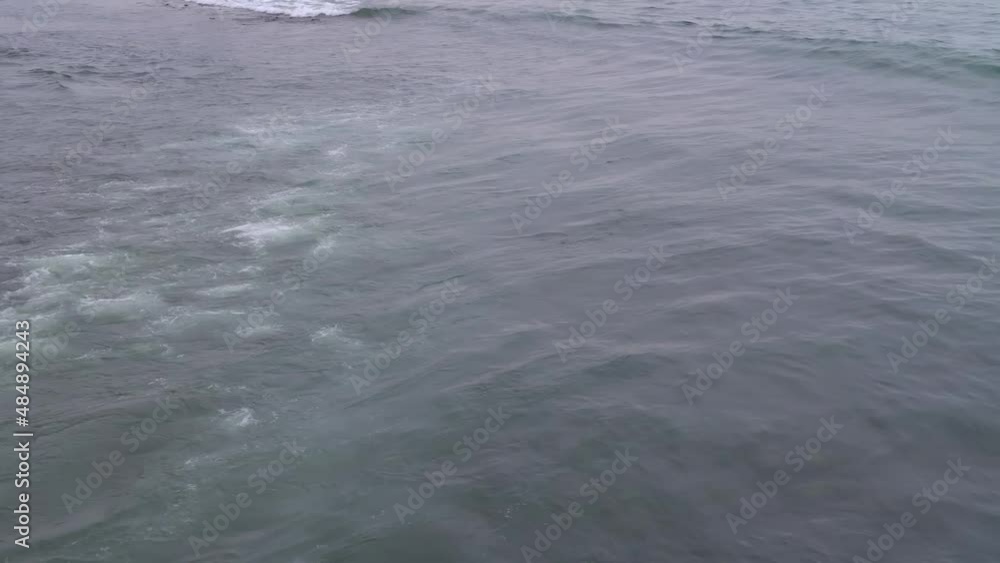 The waves are on the sea surface. Top view. Sea breeze. A wave in the ocean. The waves are on the sea surface. Top view. Sea breeze. A wave in the ocean.