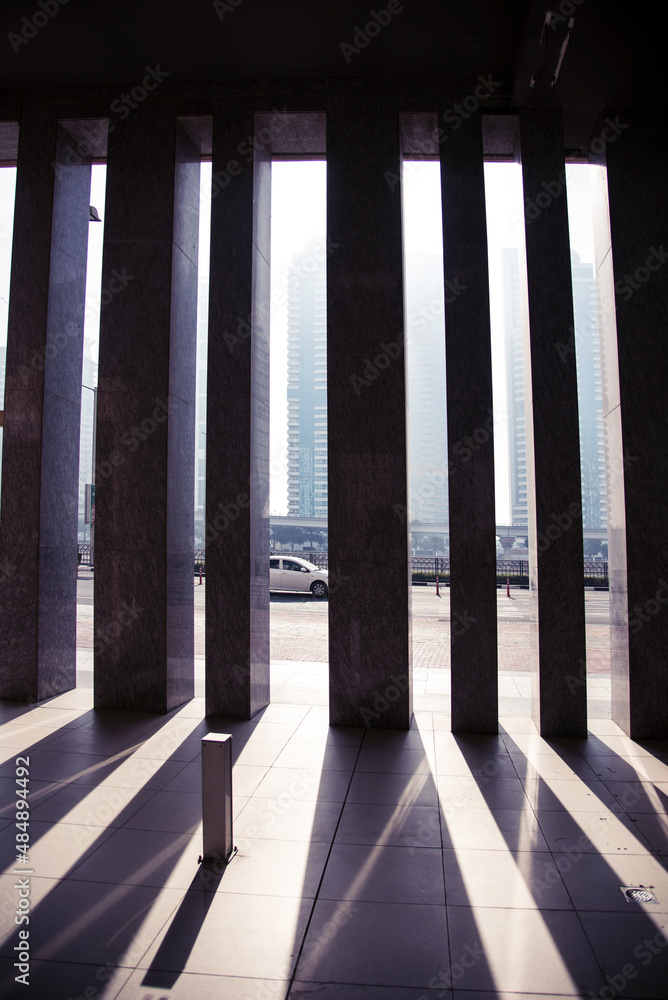 Abstract architectural image of a row of columns on a light background