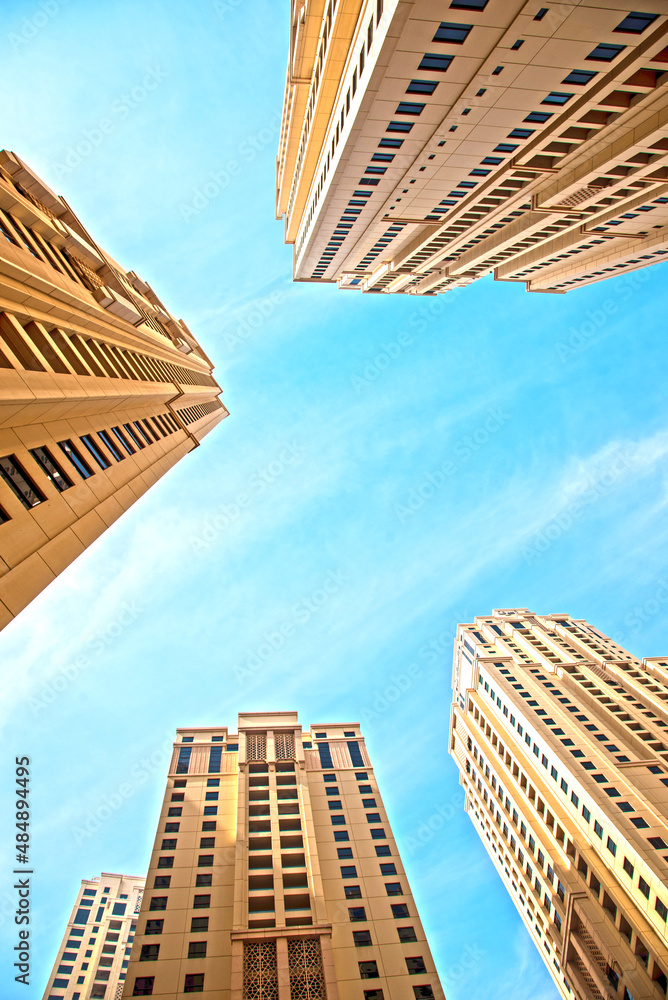 Abstract architectural image with skyscrapers on sky background.