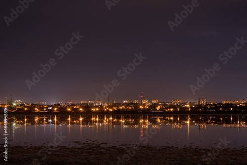 view of the night city with reflection in the water