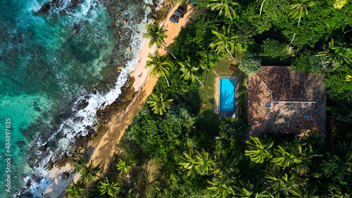 Aerial view of a villa with a swimming pool in the tropics. Hiriketiya beach, Sri Lanka. High quality photo