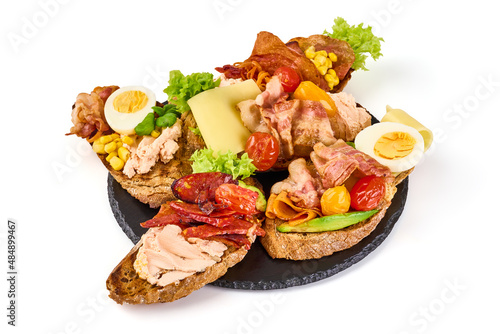 Assorted bruschetta with various toppings, isolated on white background. High resolution image.