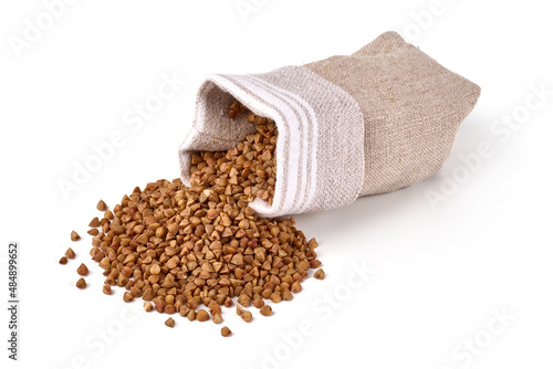 Buckwheat grains in a sack, isolated on white background.