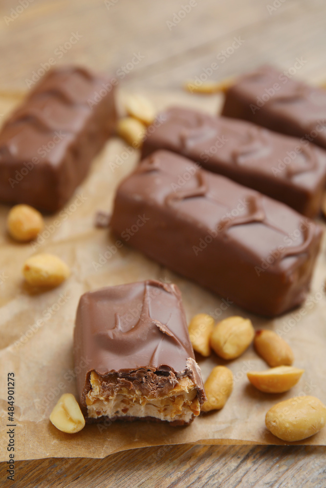 Chocolate bars with caramel, nuts and nougat on table Chocolate bars with caramel, nuts and nougat on table