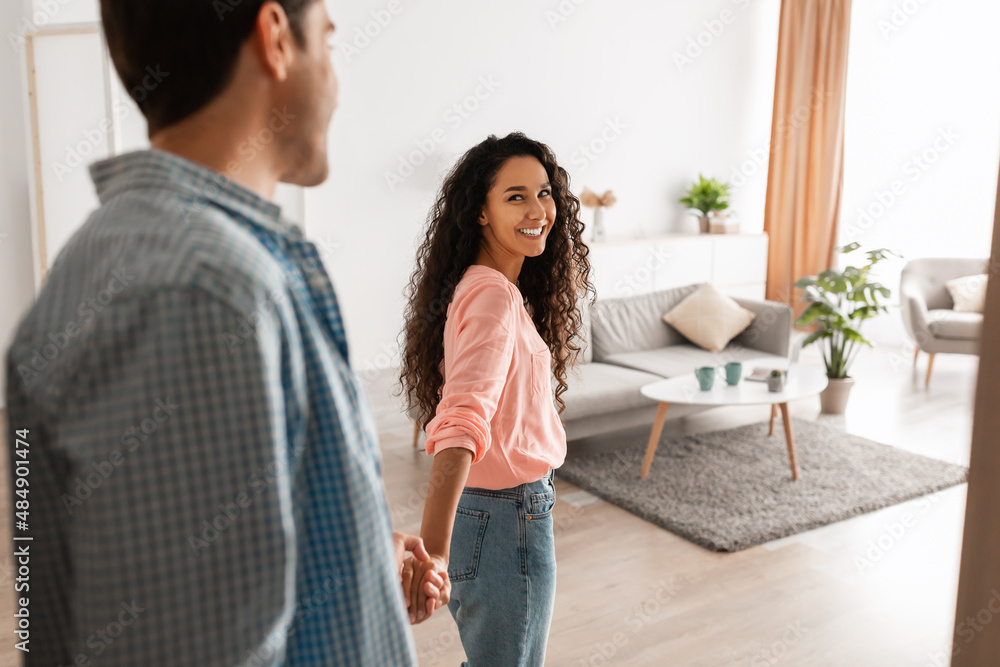 Happy lady inviting gyt to enter home Happy lady inviting gyt to enter home