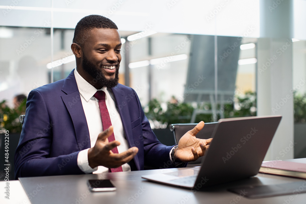 Happy black businessman having video chat, using laptop Happy black businessman having video chat, using laptop