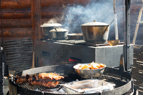 mobile open-air kitchen, food is cooked and steamed in pots and cauldrons