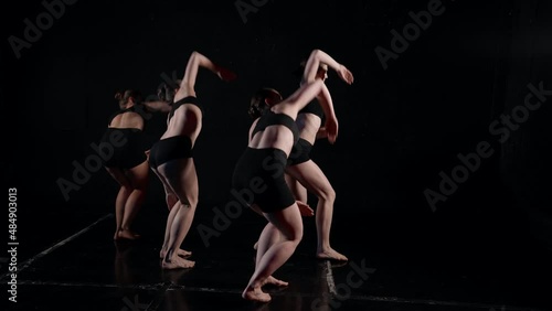 rehearsal in dance class, four young ballerinas is training modern choreography