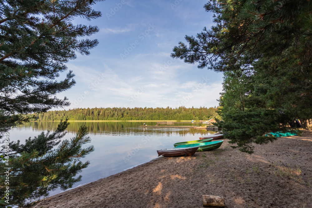 Lake with clear water at dawn and two boat on the shore Lake with clear water at dawn and two boat on the shore