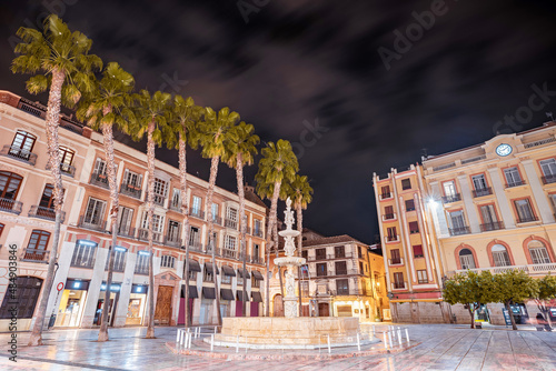 Panoramic view of Constitution square at night in the centre of Malaga, Spain. Beautiful cityscape of the sightseeing spots of the city