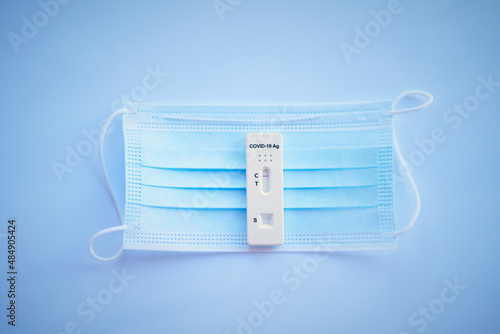 Antigen Test For Covid-19 And Face Mask On Blue Background 