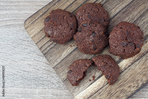 flat lay dark chocolate cookies on a chopping board