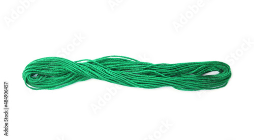 Bright green embroidery thread on white background