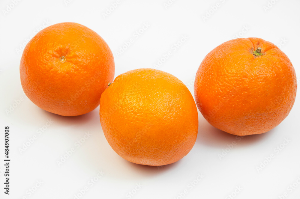 juicy oranges on a white background. sweet big tangerines on the table.orange citrus fruits on a light texture juicy oranges on a white background. sweet big tangerines on the table.orange citrus fruits on a light texture