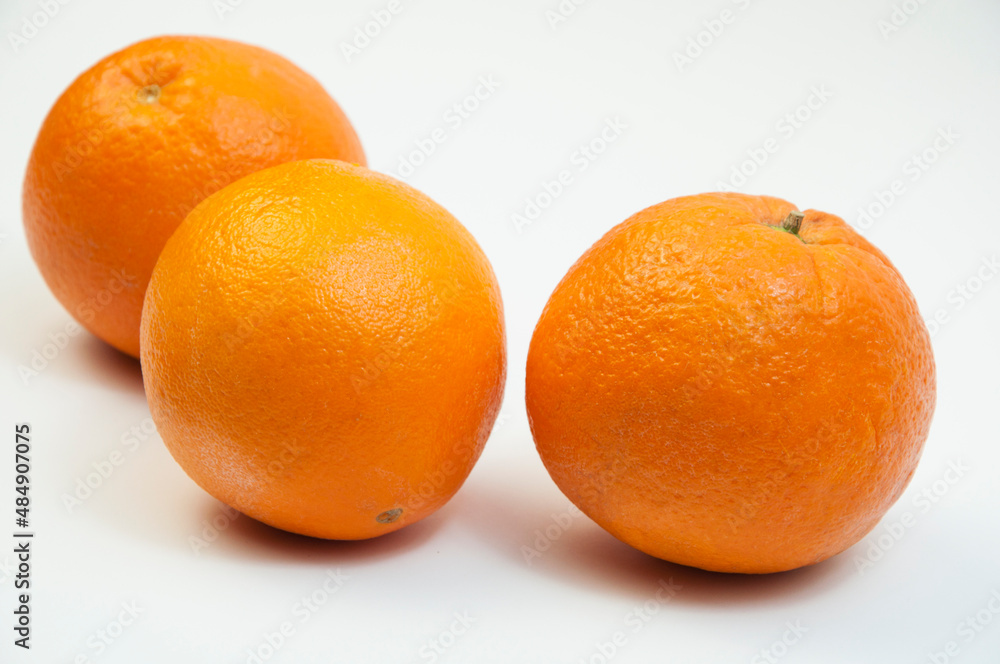juicy oranges on a white background. sweet big tangerines on the table.orange citrus fruits on a light texture juicy oranges on a white background. sweet big tangerines on the table.orange citrus fruits on a light texture