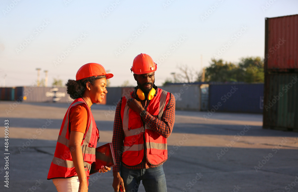 Foreman and worker checking and control loading containers box in import-export area from Cargo freight ship. Foreman and worker checking and control loading containers box in import-export area from Cargo freight ship.