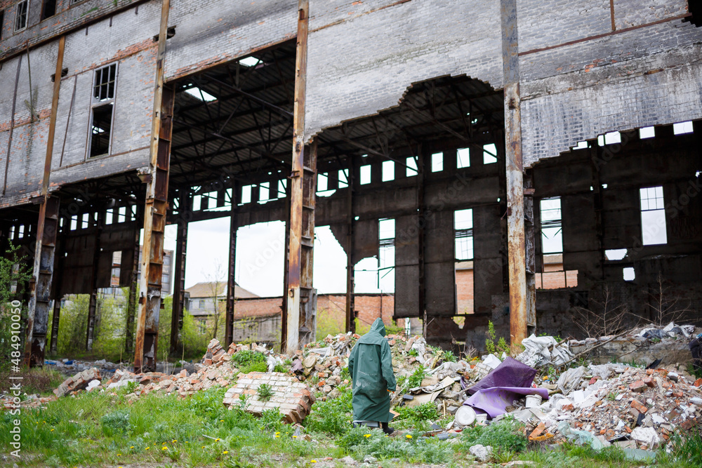 A man with a protective mask and protective clothing examines the danger zone. Ecological catastrophe. Dangerous toxic zone